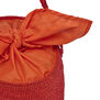 Top detail of a red raffia bucket bag with an orange cotton top.